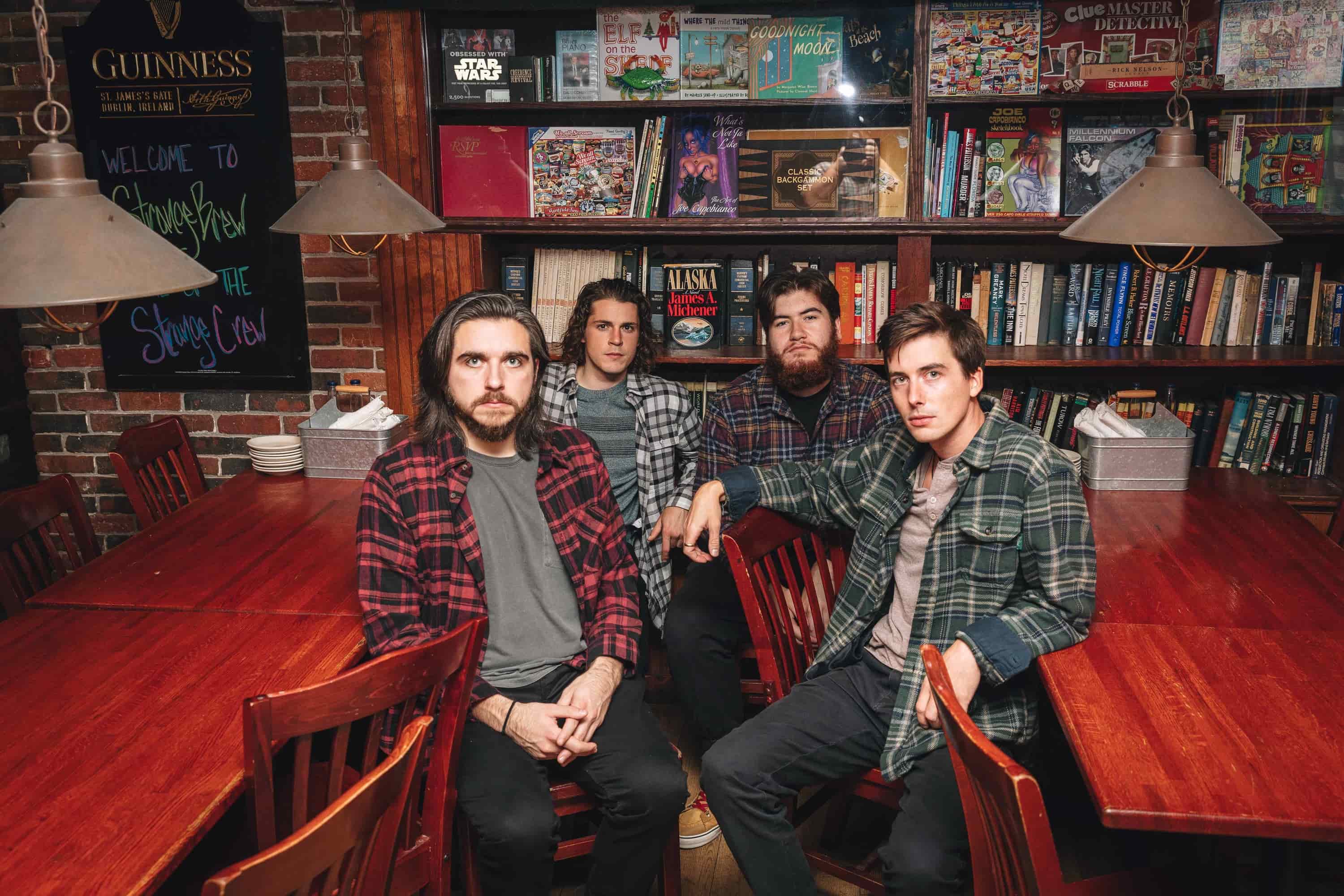 slim volume press photo with bookcase in background